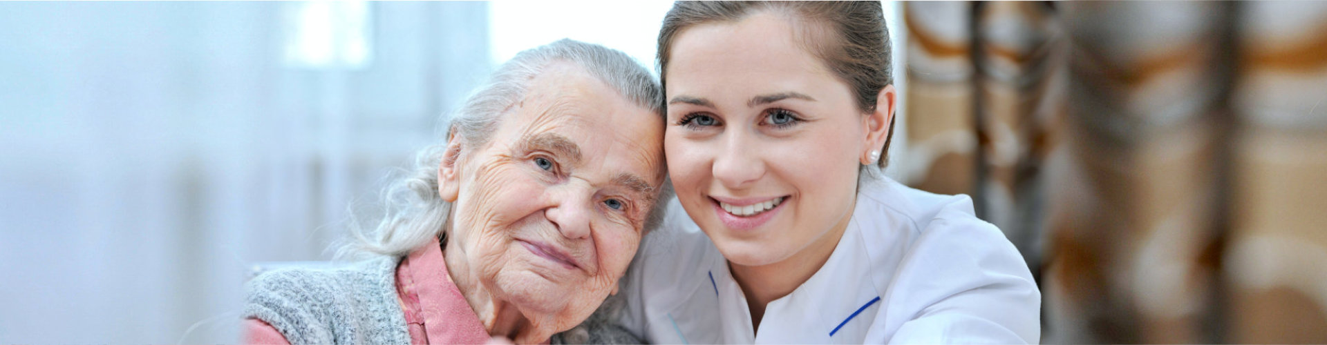caregiver and senior woman smiling indoor