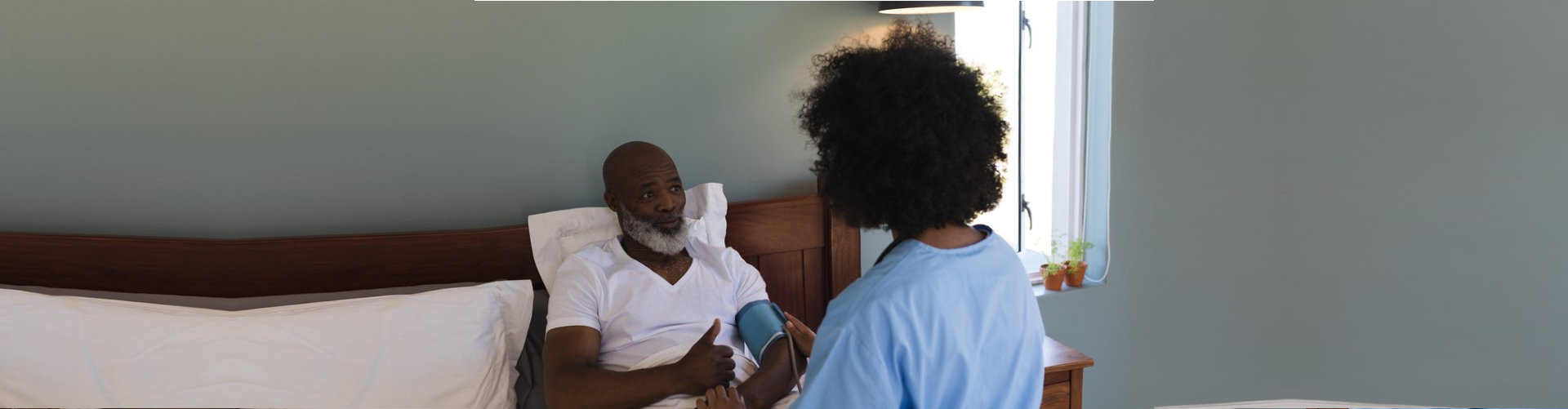 nurse checking her patient blood pressure