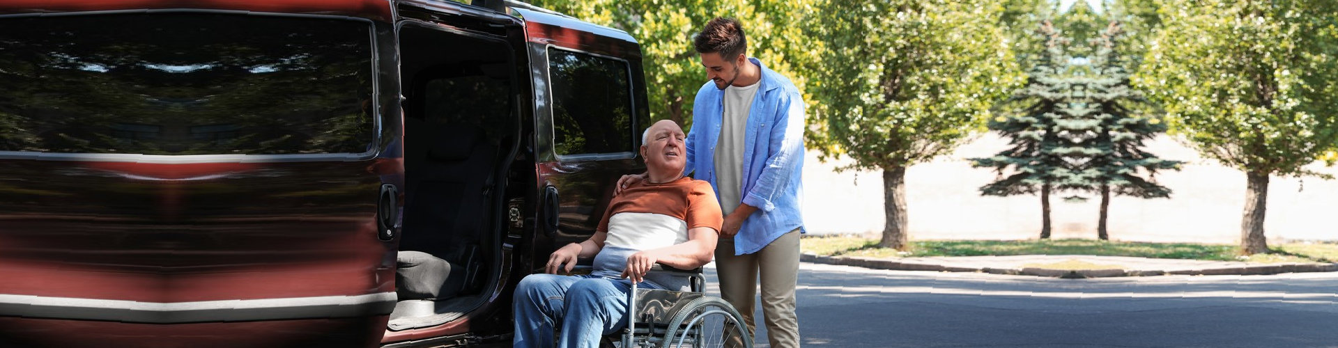 man helping his patient getting inside a van